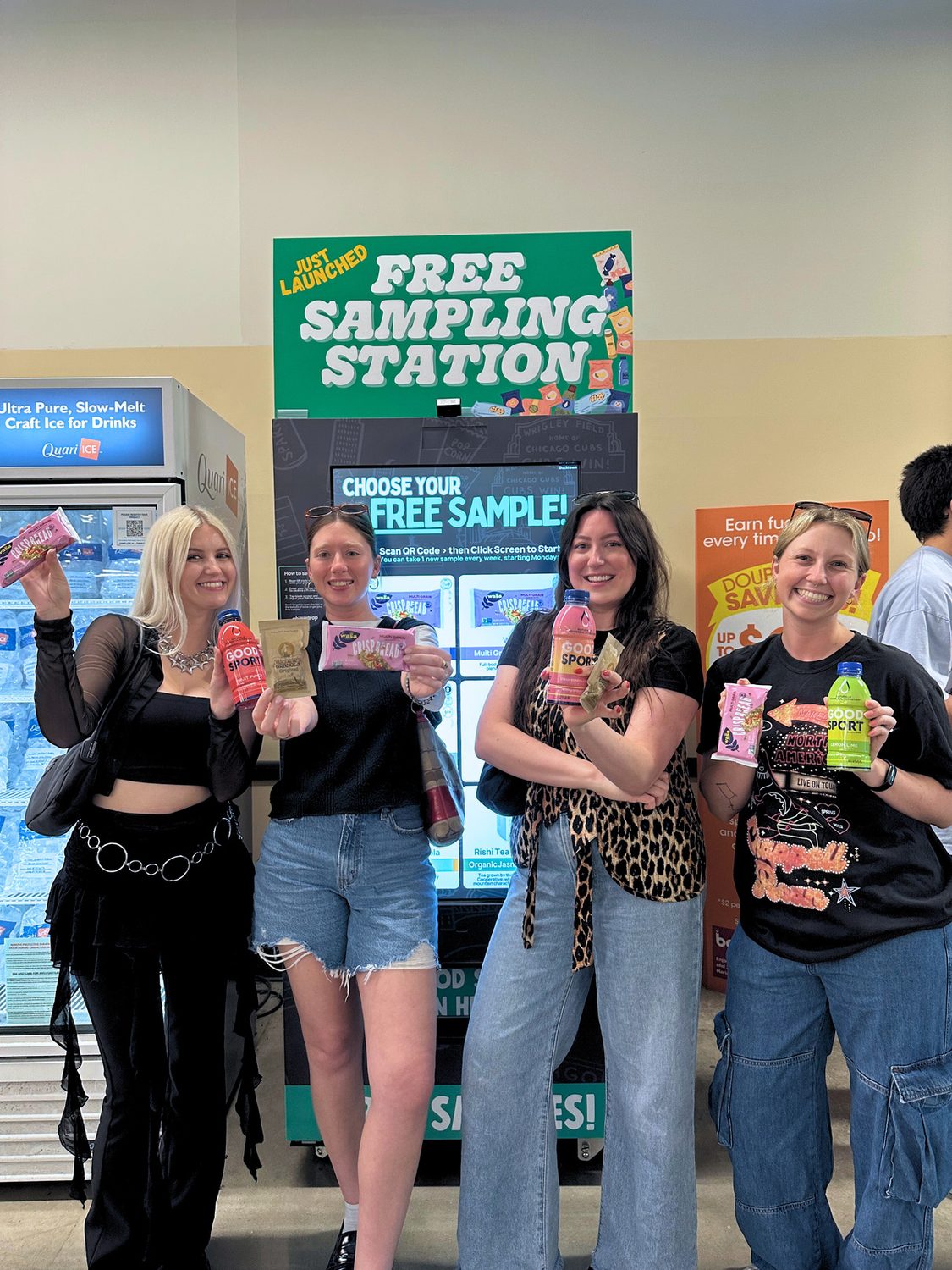 Four shoppers holding the samples they chose