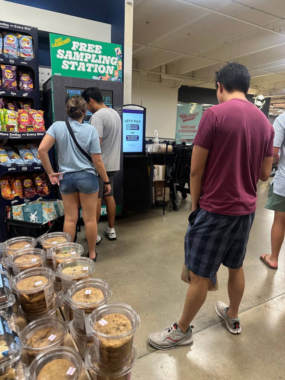 Shoppers walking past a Showdrop kiosk